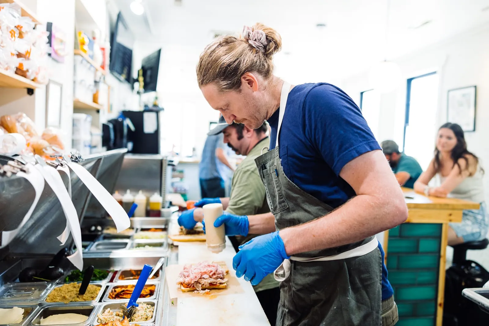 Two staff working the sandwich prep line