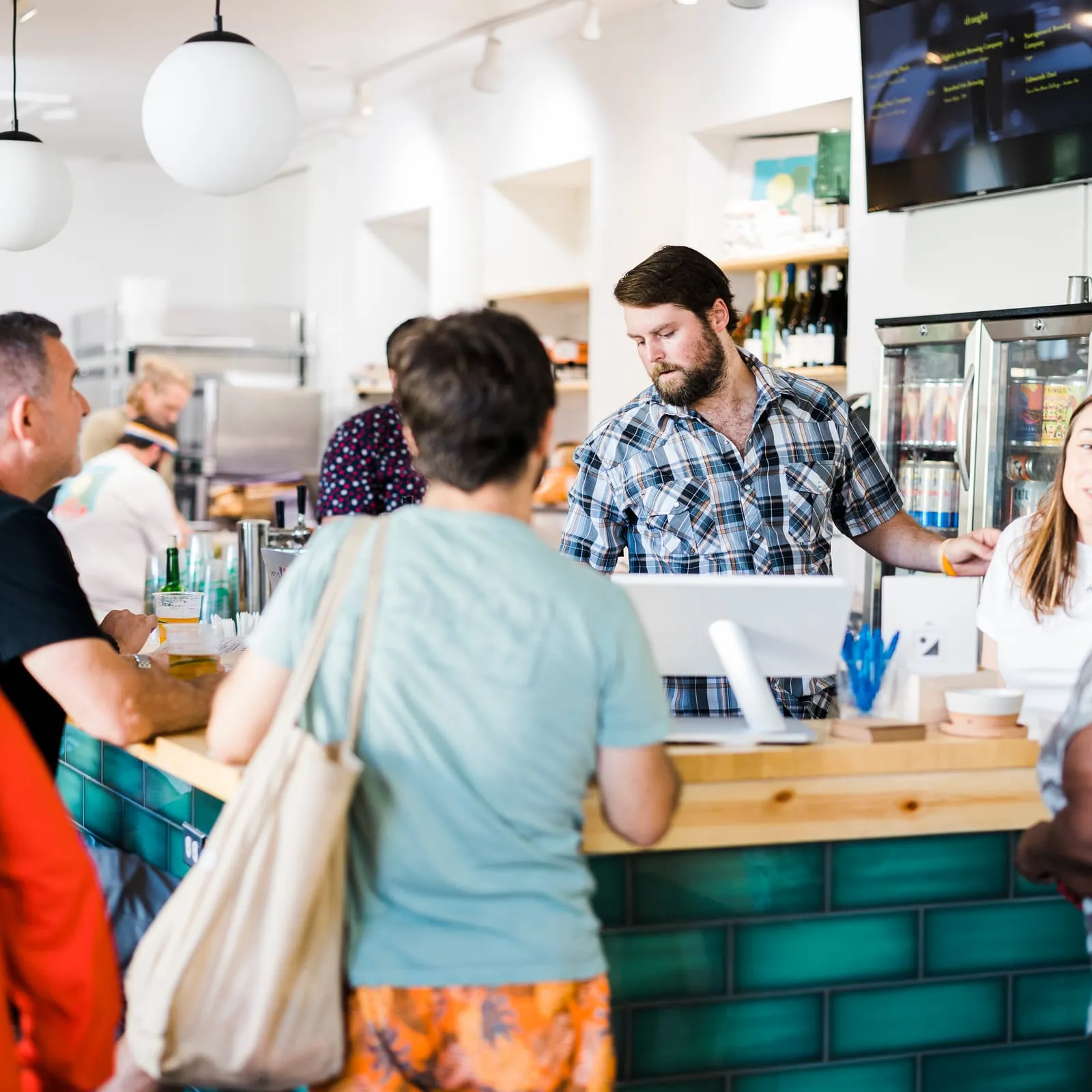Customers ordering at the green-tiled counter downtown