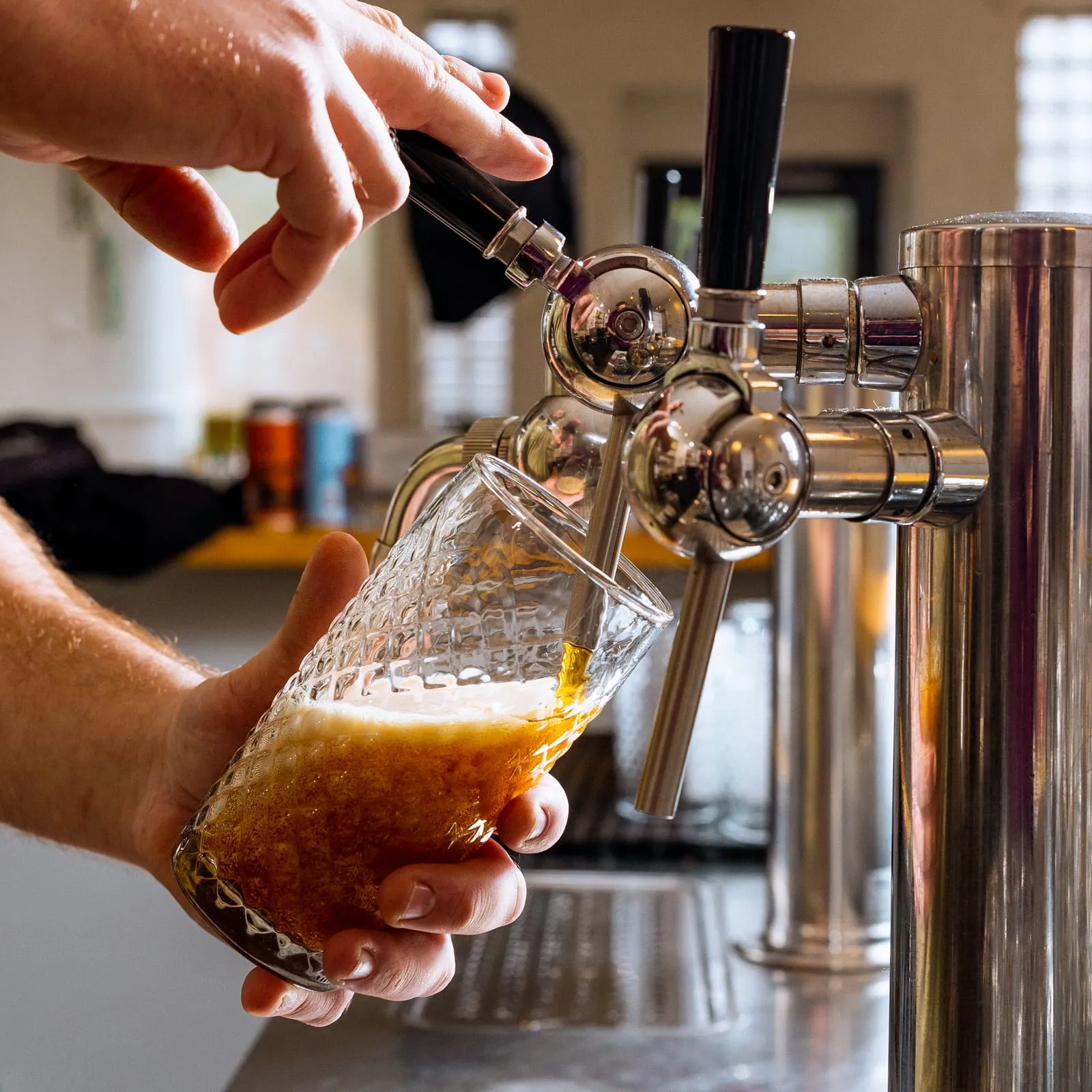 A beer being poured from the tap into a glass