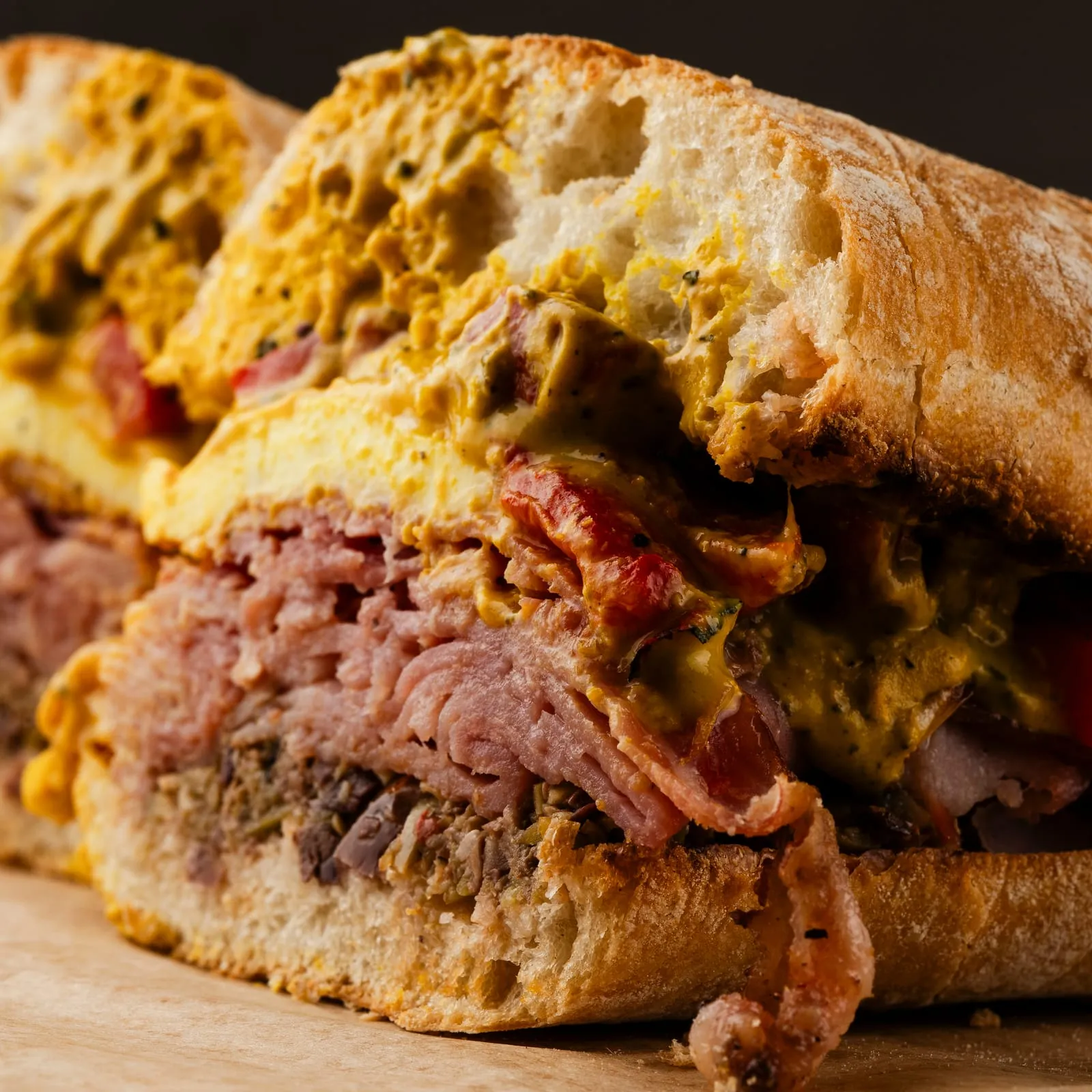 A close crop of a roast beef sandwich on ciabatta