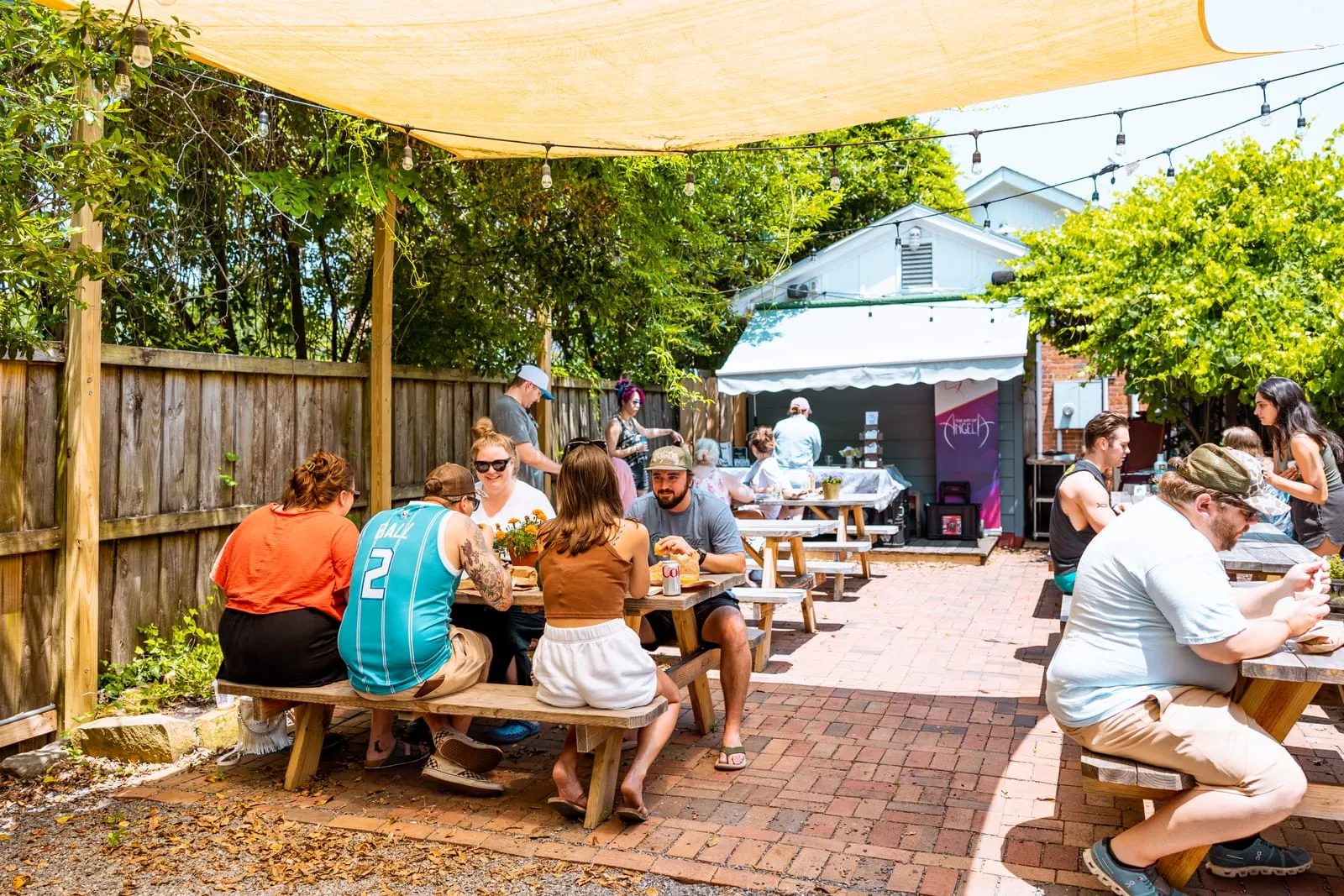 Customers eating at picnic tables on the patio
