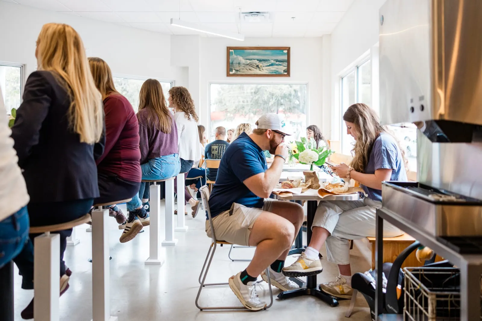 Customers eating at the high tables on Wrightsville Ave