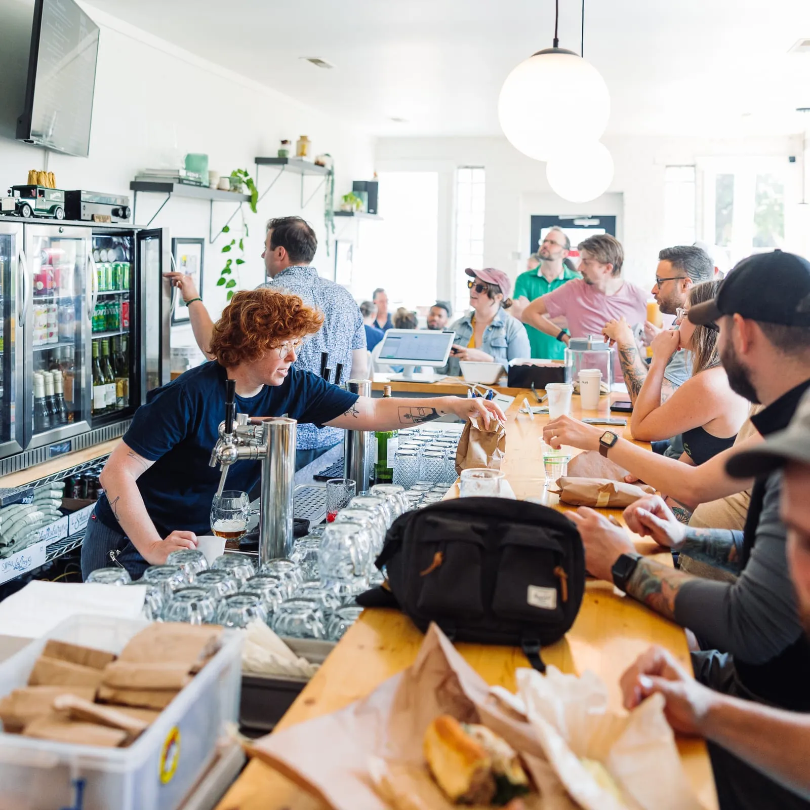 A busy counter with staff pouring and customers eating