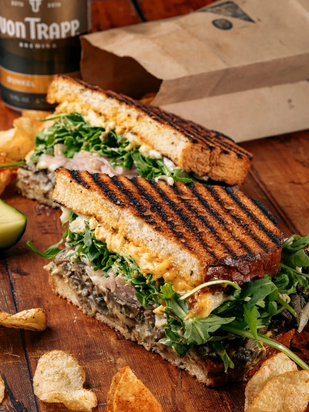 Grilled panini halves stacked with arugula