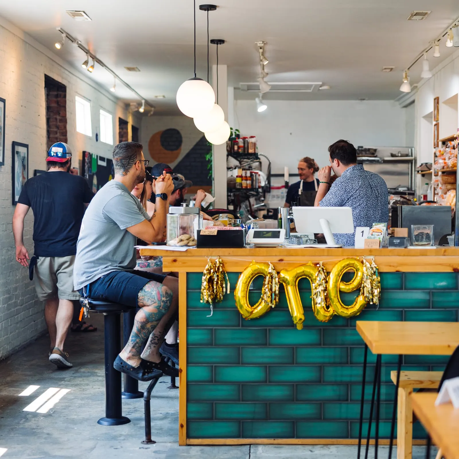 The downtown room, art on the wall and balloons on the counter