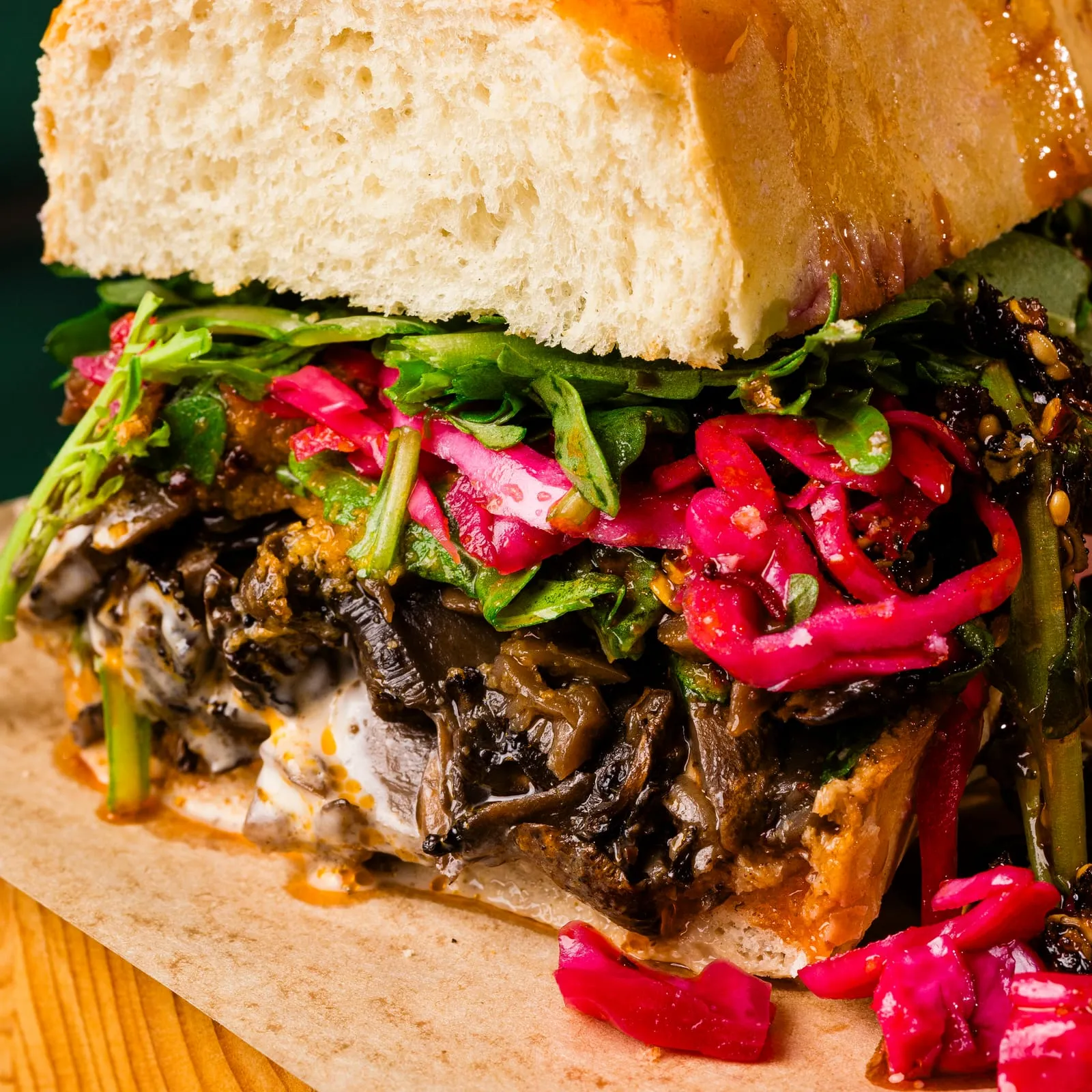 A close crop of a mushroom and pickled onion sandwich